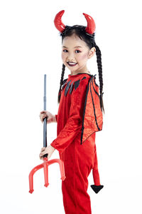 Portrait of smiling girl standing against white background