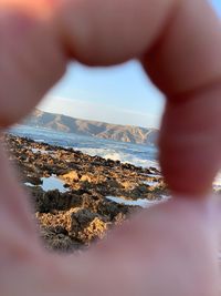 Midsection of man in sea against sky