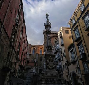 Low angle view of statue against sky in city