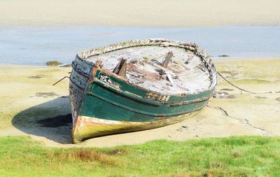 Old boat moored on beach