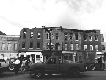 Cars on street against buildings in city