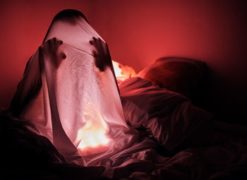 Close-up of woman lying on bed at home