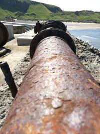 Close-up of rock by river against sky