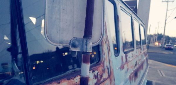 Close-up of cars on road in city