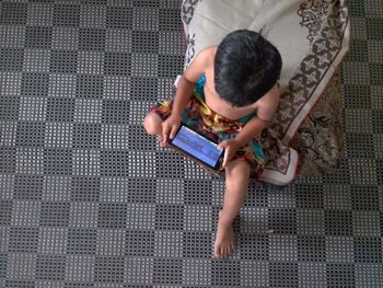 High angle view of boy using digital tablet at home