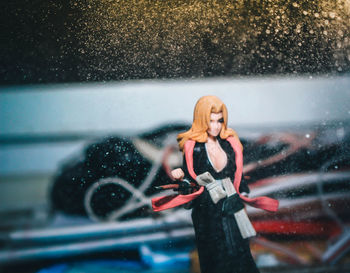 Woman standing on wet glass