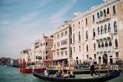 Boats in river with buildings in background