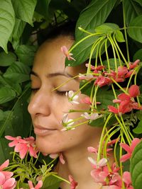 Portrait of woman with flowers with eyes closed. one with nature 