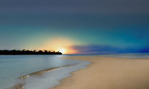 Scenic view of beach against sky during sunset