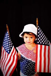Portrait of boy against black background