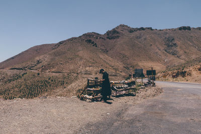 Rear view of man riding motorcycle on road