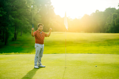 Full length of man standing on golf course