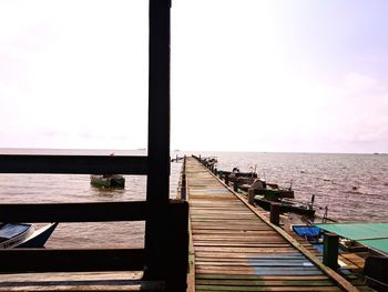 Pier over sea against sky