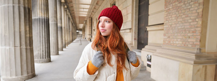 Portrait of young woman wearing hat