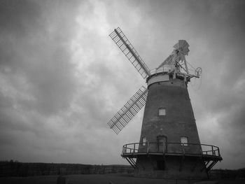 Low angle view of traditional windmill against sky