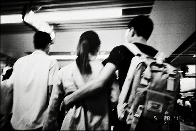 Rear view of people walking in train