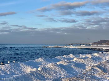 Scenic view of sea against sky during winter