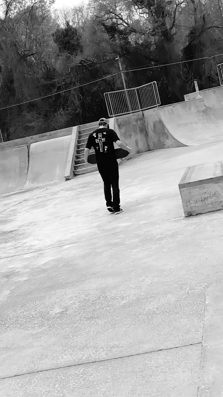 white, black, black and white, one person, winter, monochrome, full length, snow, monochrome photography, day, lifestyles, leisure activity, tree, nature, men, skateboard, person, footwear, skateboard park, rear view, plant, adult, cold temperature, outdoors, skateboarding, architecture, clothing, sports