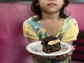 Midsection of woman holding ice cream