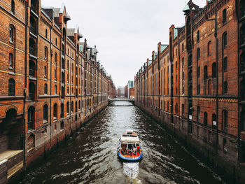 View of canal amidst buildings in city