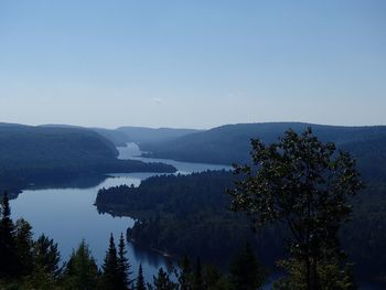 Scenic view of lake and mountains against clear sky