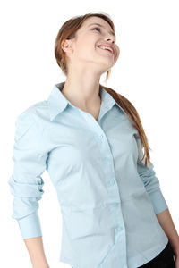 Smiling young woman looking away against white background
