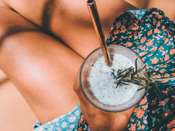 High angle view of woman holding drink