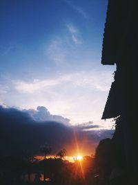 Low angle view of silhouette built structure against sunset sky