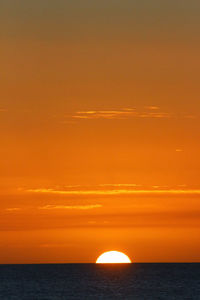 Scenic view of sea against orange sky