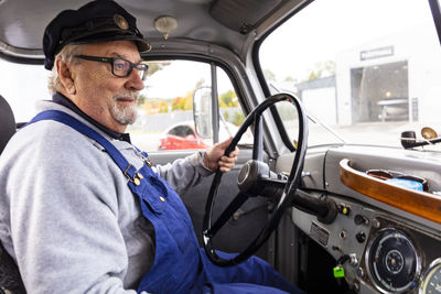 Senior man in vintage car