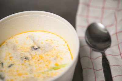 Close-up of soup in bowl by spoon on table