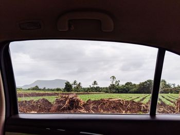 Scenic view of landscape seen through car window