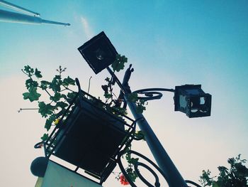 Low angle view of street light against blue sky