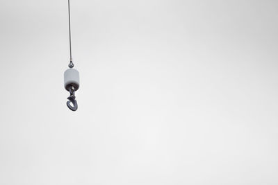 Low angle view of light bulb against sky