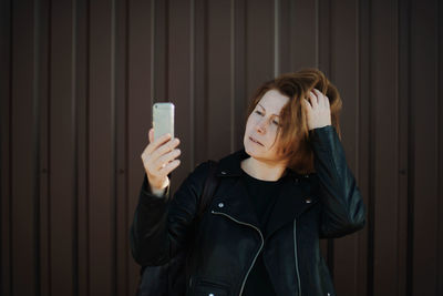 Portrait of young woman using mobile phone