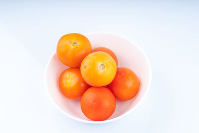 High angle view of fruits in bowl against white background