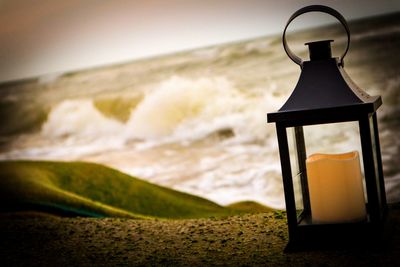 Lifeguard hut on beach against sky during sunset