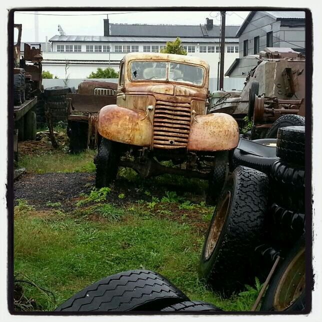 transfer print, grass, auto post production filter, building exterior, land vehicle, abandoned, built structure, old, obsolete, transportation, architecture, mode of transport, car, day, outdoors, damaged, metal, field, chair, no people