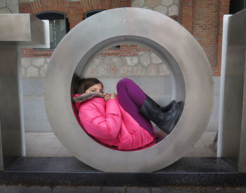Portrait of girl playing in metallic structure