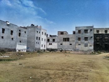 Buildings against blue sky and clouds