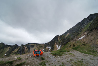 Camping gear on edge of mountain hill landscape photo