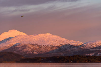 Scenic view of snowcapped mountains against sky during sunset