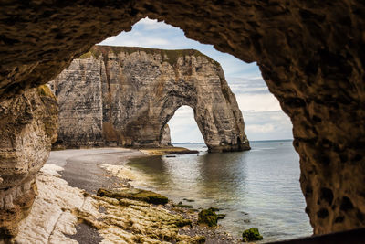 Scenic view of sea seen through cave