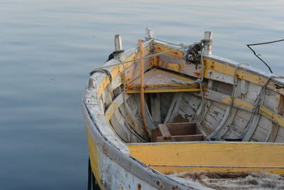 Abandoned boat moored on sea