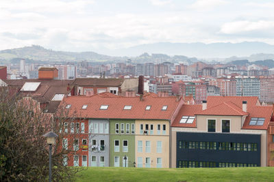 Residential buildings in town against sky