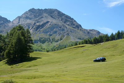 Scenic view of land and mountains against sky