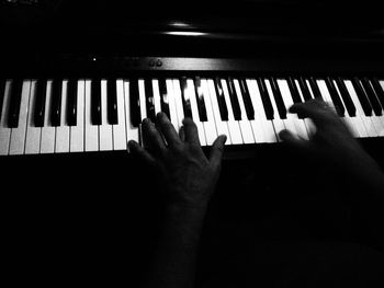 Close-up of hands playing piano