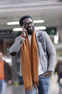 Businessman talking on phone while walking at airport