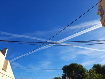 Low angle view of cables against blue sky