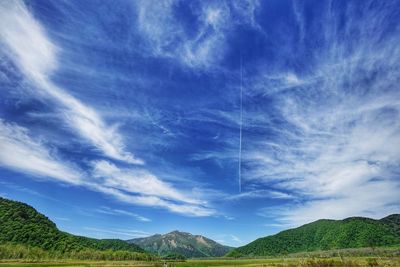 Scenic view of mountains against blue sky